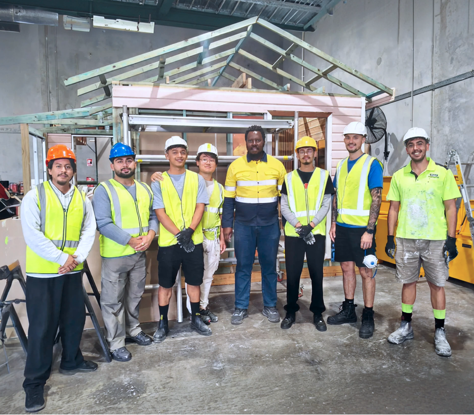 Vocational education students and trainer in a construction workshop